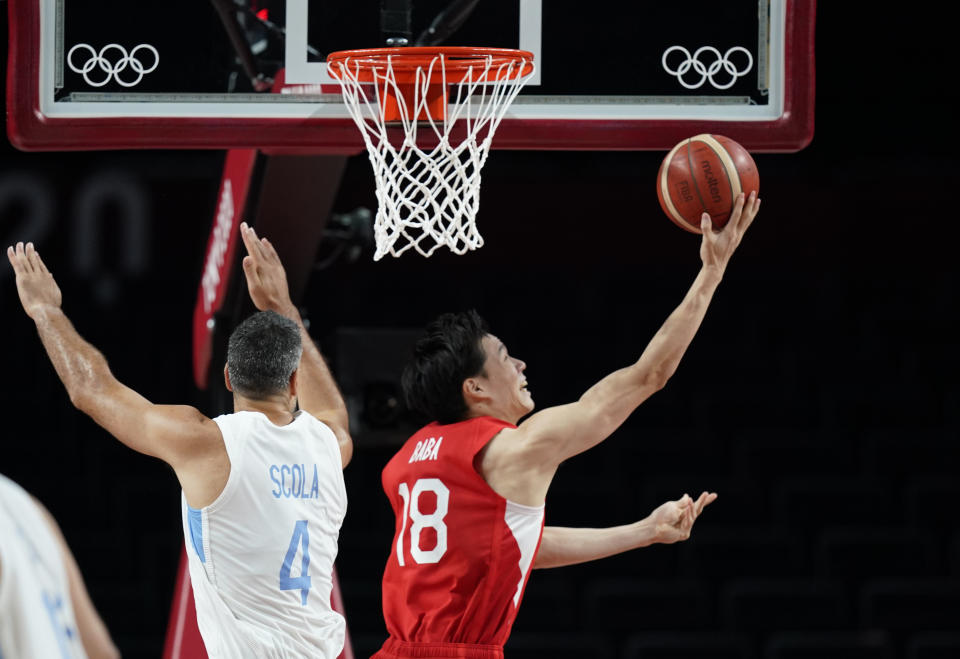 Japan's Yudai Baba (18), right, drives to the basket past Argentina's Luis Scola (4) during men's basketball preliminary round game at the 2020 Summer Olympics, Sunday, Aug. 1, 2021, in Saitama, Japan. (AP Photo/Charlie Neibergall)