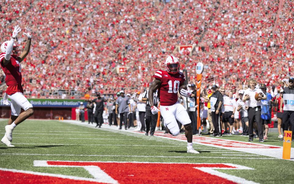 Nebraska's Anthony Grant (10) runs in a touchdown as Marcus Washington (7) celebrates nearby during the first half against North Dakota in an NCAA college football game Saturday, Sept. 3, 2022, in Lincoln, Neb. (AP Photo/Rebecca S. Gratz)