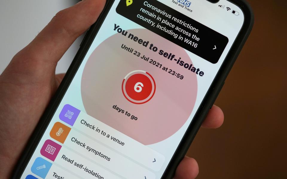In this photo illustration a smartphone uising the NHS Covid-19 app alerts the user "You need to self-isolate" on July 18, 2021 in Knutsford, England. Two-thirds of UK adults have received both Covid-19 doses, yet the NHS "Test and Trace" service is still issuing self-isolation orders to fully vaccinated individuals who have been exposed to infected people. 