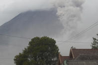 Mount Semeru releases volcanic materials during an eruption as seen from Lumajang district, East Java province, Indonesia, Monday, Dec. 6, 2021. The highest volcano on Java island spewed thick columns of ash into the sky in a sudden eruption Saturday triggered by heavy rains. Villages and nearby towns were blanketed and several hamlets buried under tons of mud from volcanic debris. (AP Photo/Hendra Permana)