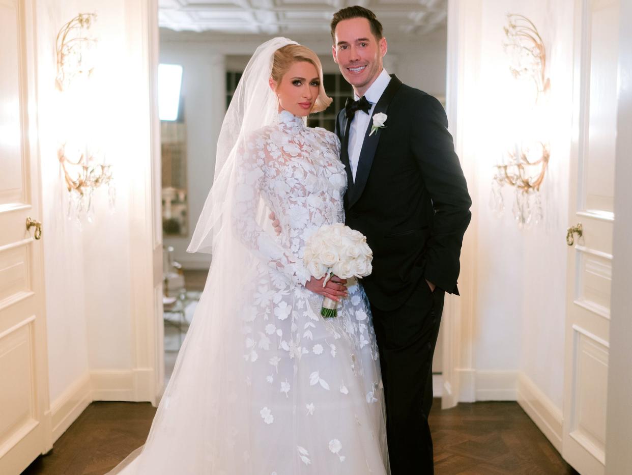 Paris Hilton and Carter Reum pose in their wedding attire.