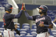 Washington Nationals' Juan Soto (22) and Josh Bell (19) score on a single by Keibert Ruiz during the fifth inning of a baseball game against the Miami Marlins, Monday, Sept. 20, 2021, in Miami. (AP Photo/Marta Lavandier)