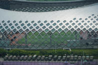 Armored vehicles and troop trucks are parked in a lot by Shenzhen Bay Stadium in Shenzhen, China Friday, Aug. 16, 2019. Armored vehicles belonging to China's paramilitary People's Armed Police were parked in the sports complex across the border in Hong Kong, in what some have interpreted as a threat against pro-democracy protesters. (AP Photo/Dake Kang)