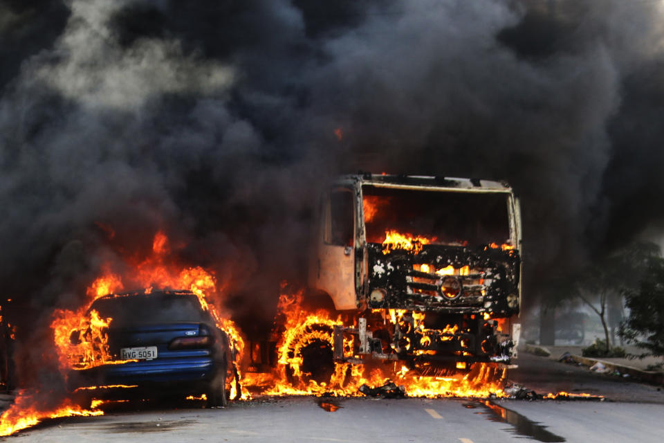 Vehicles burn in the street after attacks in the city of Fortaleza, northeastern Brazil, Thursday, Jan. 3, 2019. Brazil's newly inaugurated government has ordered military police sent to Ceara state following a wave of attacks on banks, public buildings and infrastructure over the past two days, which have hit 15 cities, including the capital. (AP Photo/Alex Gomes/O Povo)