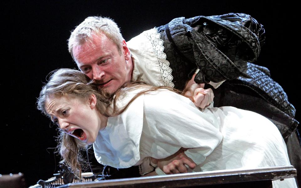 Andrea Riseborough (Isabella) is grabbed harshly by Richard Dormer (Angelo) in a 2006 Royal Shakespeare Company production of Measure for Measure - Tristram Kenton/Bridgeman Images