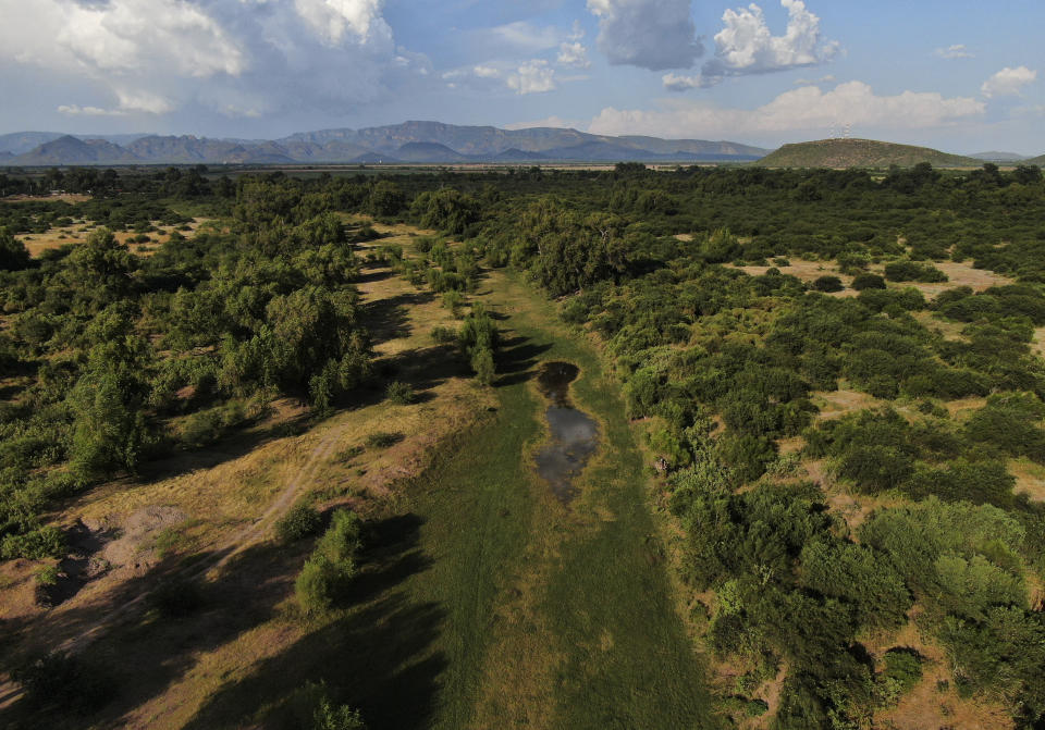 The Yaqui River is dry on the outskirts of Vicam, Mexico, Monday, Sept. 26, 2022. The Yaqui Indigenous people find themselves at the center of a perfect storm: everybody from Mexican drug cartels to water-hungry lithium mines covet their land, but they themselves live in poverty and often don’t even have running water in their homes. Water-defense leader Tomás Rojo was killed in June 2021. (AP Photo/Fernando Llano)