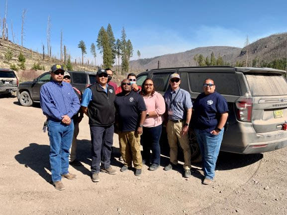 FEMA staff and Santa Clara Pueblo tribal members in the Santa Clara Canyon during FEMA Deputy Administrator Erik Hooks recent visit to New Mexico. The team visited a hazard mitigation project that took a naturalistic approach to flood mitigation. (Front row from left) James Baca of the Santa Clara Pueblo, SCP Gov. J. Michael Chavarria, FEMA Deputy Administrator Hooks, Paula Gutierrez (FEMA), and Garrett Altmann and Daniel Tafoya from Santa Clara Pueblo. (Back row from left) Santa Clara Pueblo's Donald Suazo, Jude Chavarria and Tribal Sheriff Joseph Gutierrez (Photo/Charles Shaw/Courtesy FEMA)