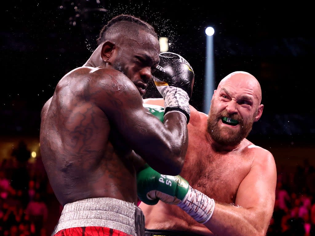 Tyson Fury punches Deontay Wilder during their WBC heavyweight title fight at T-Mobile Arena (Getty)