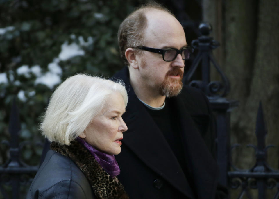 Ellen Burstyn and Louis C.K. arrive for the funeral of actor Philip Seymour Hoffman at the Church of St. Ignatius Loyola, Friday, Feb. 7, 2014 in New York. Hoffman, 46, was found dead Sunday of an apparent heroin overdose. (AP Photo/Mark Lennihan)