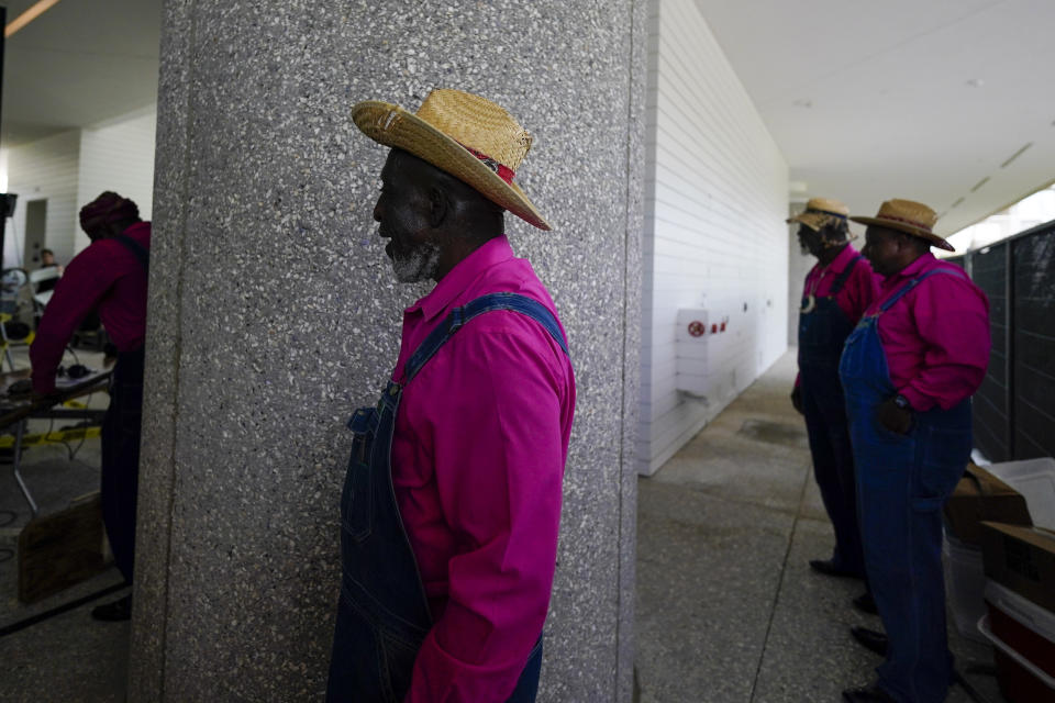 Members of the McIntosh County Shouters get ready to perform during the dedication ceremony for the opening of the International African American Museum on Saturday, June 24, 2023, in Charleston, S.C. Overlooking the old wharf at which nearly half of the enslaved population first entered North America, the 150,000-square foot museum houses exhibits and artifacts exploring how African Americans' labor, perseverance, resistance and cultures shaped the Carolinas, the nation and the world.(AP Photo/Chris Carlson)