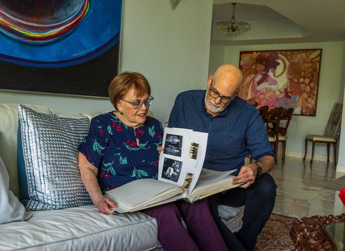 Evelyn Walg Grunberg and her son Henry Grunberg look through a family album in her apartment in Aventura. They will gather in France with other family members over the summer to commemorate their grandmother’s escape from Nazi Europe to Spain through the Pyrenees in 1942.