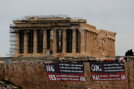 Members of the Greek Communist Party hang banners in English and Greek against the agreement reached by Greece and Macedonia to resolve a dispute over the former Yugoslav republic's name, next to the Parthenon temple atop the Acropolis Hill, in Athens, Greece, January 24, 2019. REUTERS/Alkis Konstantinidis