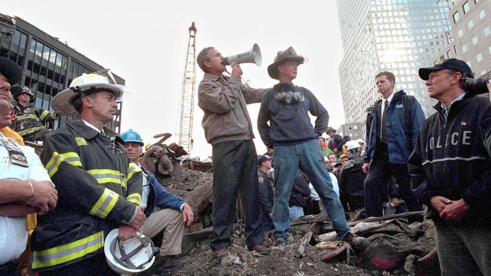 PHOTO: President George W. Bush speaks to rescue workers, firefighters and police officers from the rubble of Ground Zero September 14, 2001 in New York City. (Eric Draper/White House/Getty Images)