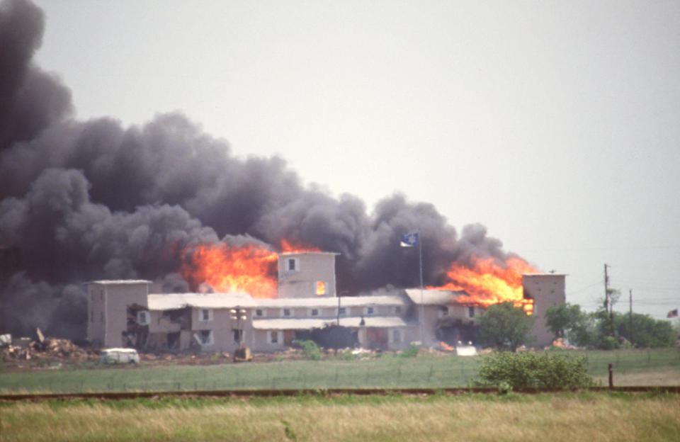 Fire consumes the Branch Davidian compound near Waco, Texas, during the FBI assault to end the standoff with cult leader David Koresh and his followers on April 19, 1993. / Credit: Greg Smith/Corbis via Getty Images