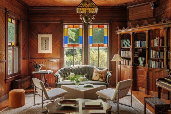 Other than blocking off some exposed plumbing and repairing the fireplace, the team left the library relatively untouched. "We wanted to preserve all the beautiful wood and stained glass and add a couple modern pieces,