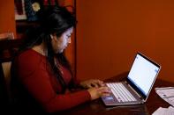 Belen Cruz helps her daughter to sign in online as schools resumed with online learning in York City