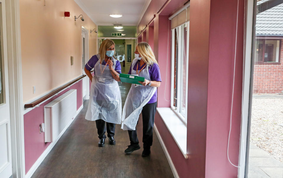 Care workers Jane Ward (left) and Cath Roe on their rounds at Ashwood Court residential care home in Lowton, Warrington, as it reopens to visitors for the first time since lockdown began in March.