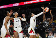 Seattle Storm guard Jewell Loyd (24) has her shot blocked by Las Vegas Aces forward Alysha Clark (7) as forward A'ja Wilson (22) and forward Candace Parker, left, look on during the first half of a WNBA basketball game, Saturday, May 20, 2023, in Seattle. (AP Photo/Lindsey Wasson)