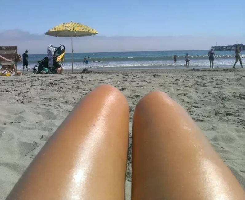 legs on a beach that look like hot dogs