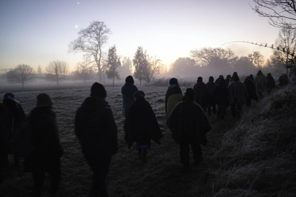 Mapuche community members walk to the Pilmaiquen River for a purification ritual in the culmination of the multiday celebration of We Tripantu, the Mapuche New Year, in Carimallin, southern Chile, on Sunday, June 26, 2022. The sacred holiday coincides with the winter solstice in the Southern Hemisphere. (AP Photo/Rodrigo Abd)