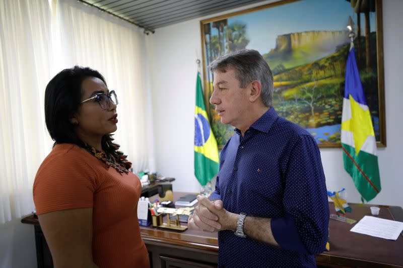 Irisnaide Silva, 32, an Indigenous leader of one of two main indigenous groups in the Amazonian state of Roraima, talks with Roraima governor Antonio Denarium in Boa Vista