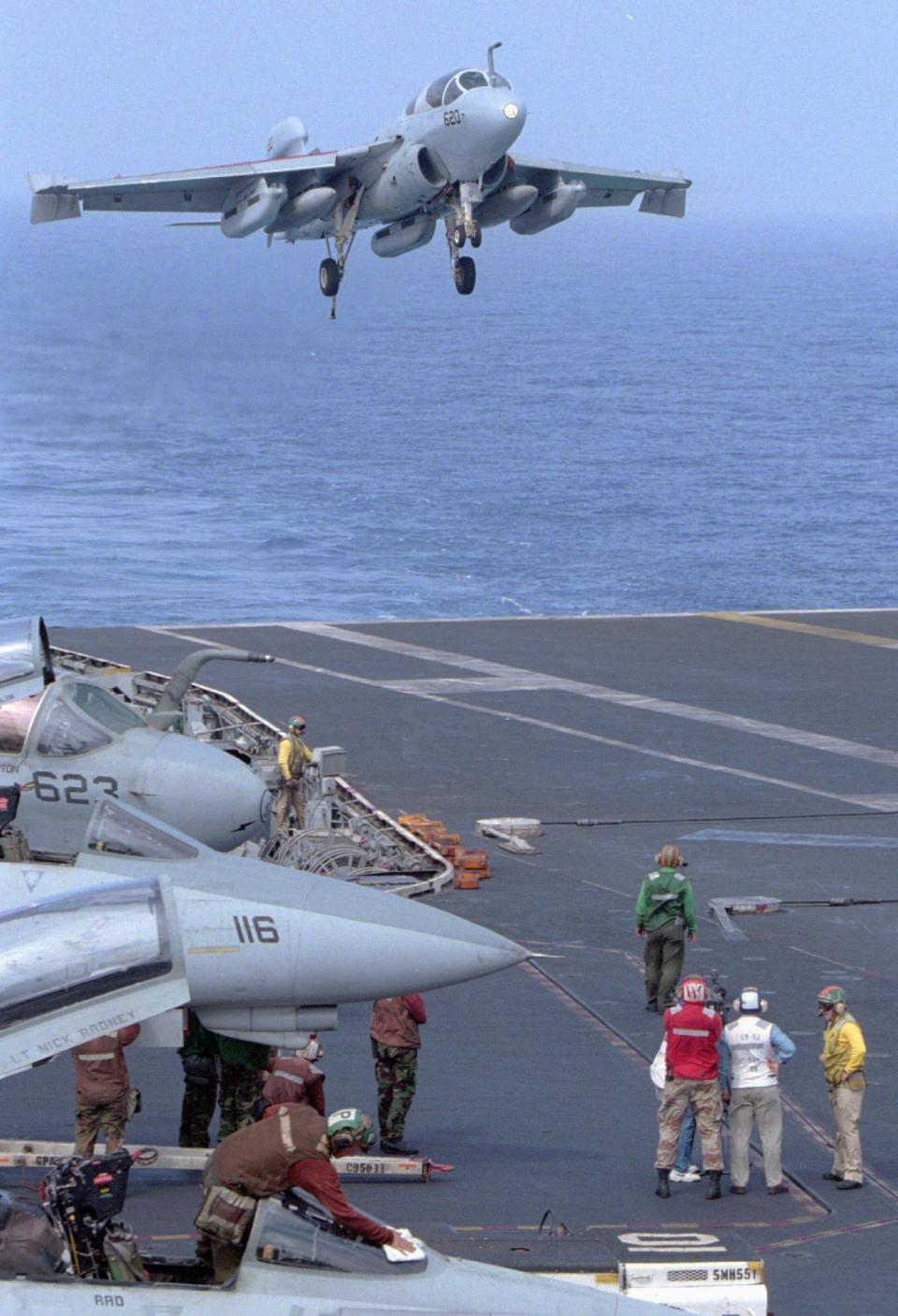 FILE - A U.S. jet fighter is about to land on the deck of aircraft carrier USS Independence as tens of fighter planes conduct practice in the public waters near the Straits of Taiwan Wednesday, March 13, 1996. In 1997, Beijing grumbled but swallowed its irritation when then-Speaker Newt Gingrich of the U.S. House of Representatives visited Taiwan. A quarter-century later, news reports that the current speaker, Nancy Pelosi, might visit Taiwan, Beijing is warning of “forceful measures” including military action if she does. (AP Photo/Itsuo Inouye, File)