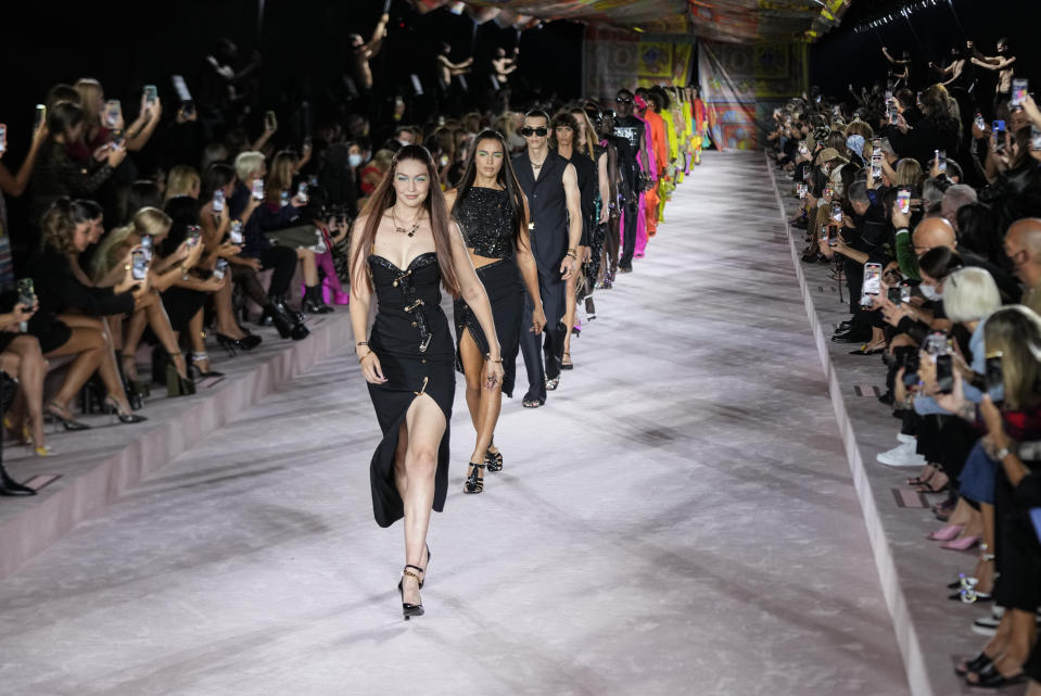 Gigi Hadid, from centre left, and Irina Shayk lead models as they wear creations for the Versace Spring Summer 2022 collection during Milan Fashion Week, in Milan, Italy, Friday, Sept. 24, 2021. (AP Photo/Luca Bruno)