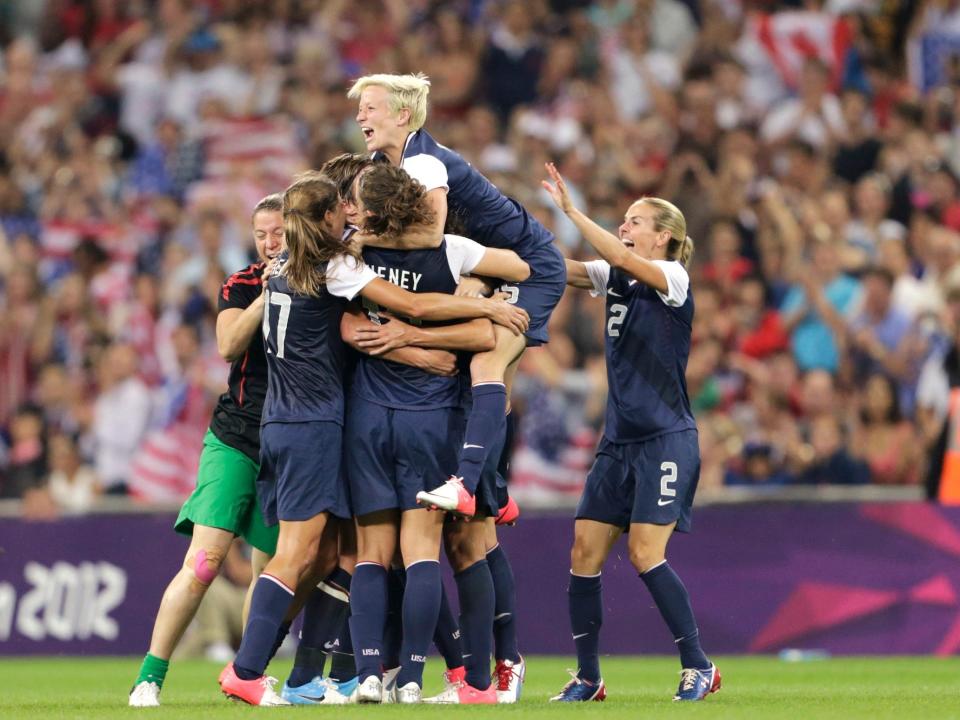 Megan Rapinoe celebrates with USWNT teammates after winning gold at the 2012 Olympics.