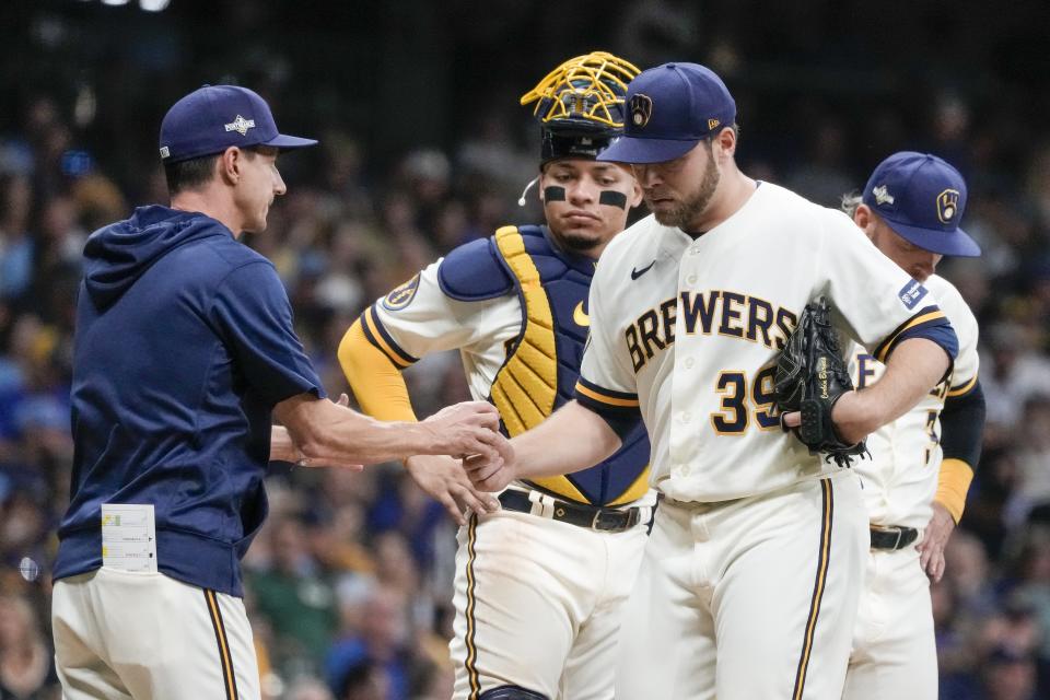 Milwaukee Brewers manager Craig Counsell takes starting pitcher Corbin Burnes out of the game during the fifth inning of a Game 1 of their National League wildcard baseball series against the Arizona Diamondbacks Tuesday, Oct. 3, 2023, in Milwaukee. (AP Photo/Morry Gash)