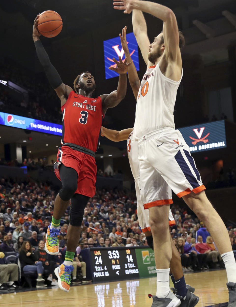 Stony Brook guard Elijah Olaniyi (3) shoots next to Virginia forward Jay Huff (30) during an NCAA college basketball game in Charlottesville, Va., Wednesday, Dec. 18, 2019. (AP Photo/Andrew Shurtleff)