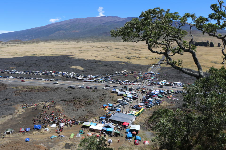 In this Sunday, July 21, 2019, photo provided by the Hawaii Department of Land and Natural Resources, protesters block a road to the summit of Mauna Kea in Hawaii. Scientists want to build the telescope atop Mauna Kea because it is one of the best sites in the world for viewing the skies. Hawaii Gov. David Ige has ordered the closure of the road as a way to clear a path for construction equipment. (Dan Dennison/Hawaii Department of Land and Natural Resources via AP)