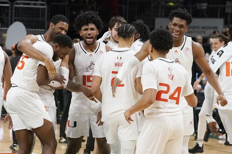 The Miami team celebrates after defeating Virginia 66-64 during an NCAA college basketball game, Tuesday, Dec. 20, 2022, in Coral Gables, Fla. (AP Photo/Marta Lavandier)