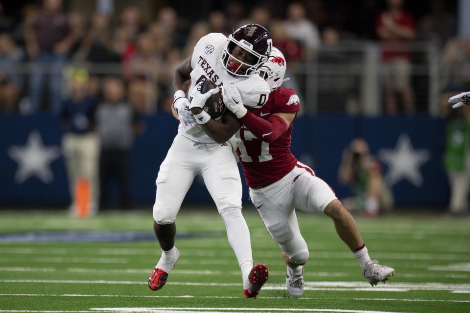 Sep 30, 2023; Arlington, Texas; Texas A&M Aggies wide receiver Ainias Smith (0) is tackled by Arkansas Razorbacks defensive back Hudson Clark (17) during the first half at AT&T Stadium. Jerome Miron-USA TODAY Sports