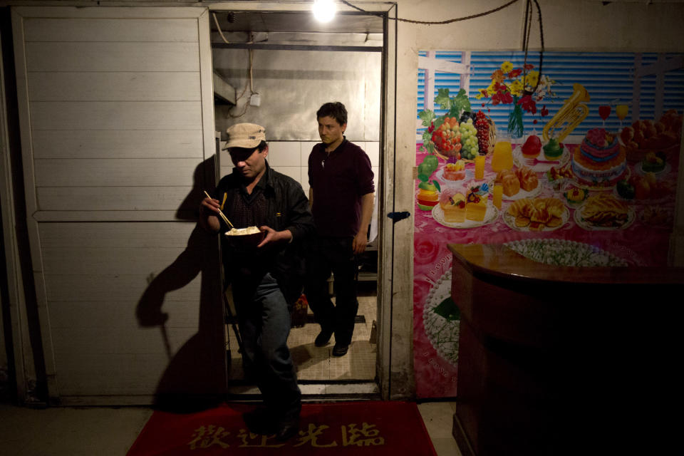 In this Monday March 3, 2014 photo, Uighur men work in the kitchen of a restaurant in Kunming, in western China's Yunnan province. China said the vicious slashing spree Saturday that killed 29 people in the southern city was the work of separatists linked to international terrorism, but the assailants’ homespun methods and low-tech weapons - nothing more than long knives - have led some analysts to suspect they didn’t get outside help. (AP Photo/Alexander F. Yuan)