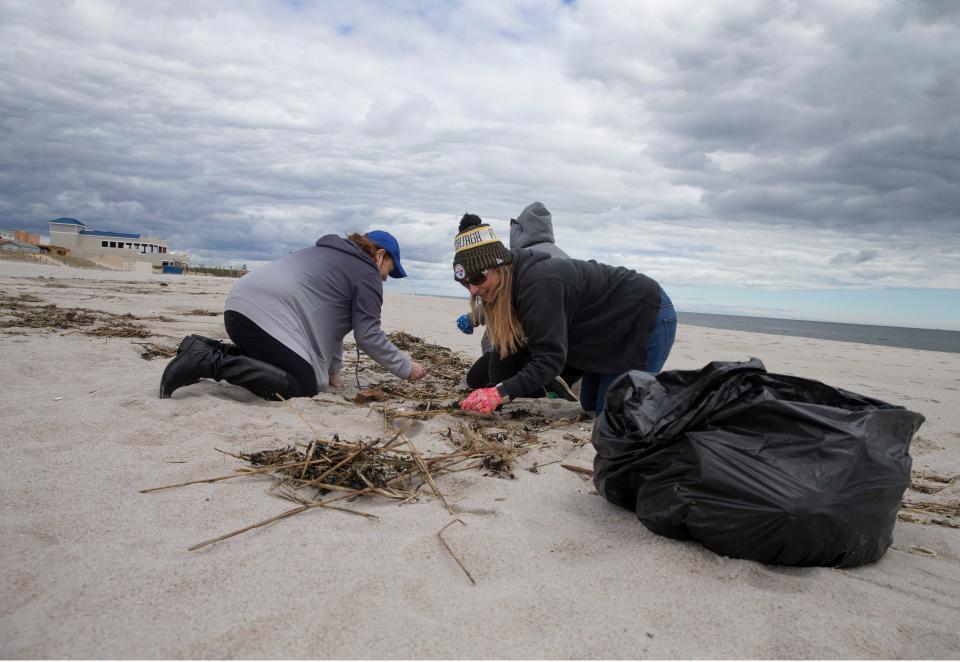 Clean Ocean Action volunteers pick up garbage off the beach in Seaside Park during a Beach Sweep in April, 2021.