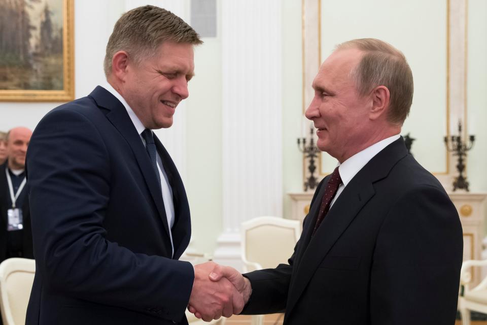 Russian president Vladimir Putin, right, shakes hands with Slovak prime minister Robert Fico during their meeting in the Kremlin in Moscow, Russia (AP)