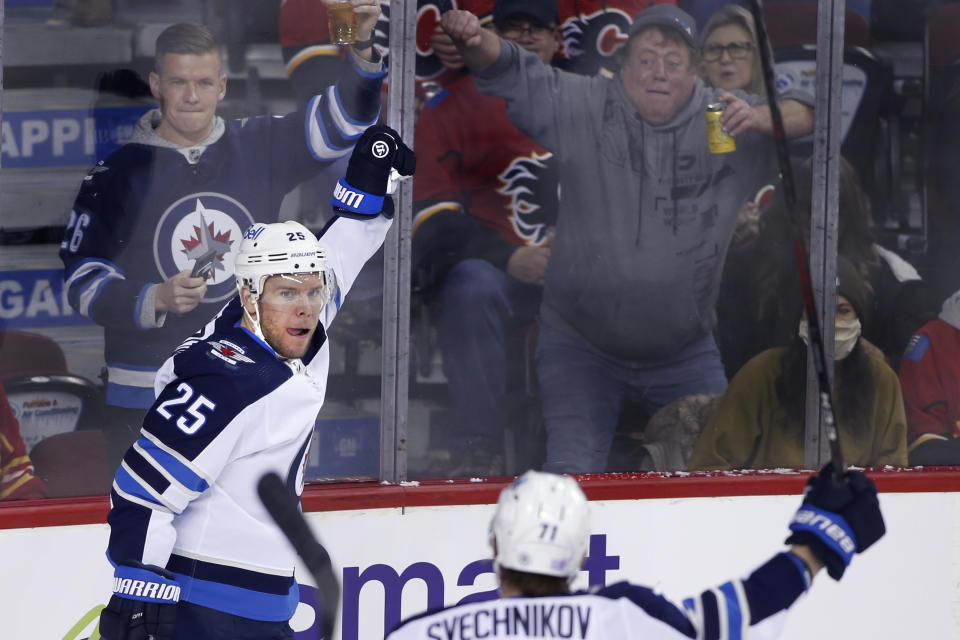 Winnipeg Jets' Paul Stastny celebrates his goal against the Calgary Flames with Evgeny Svechnikov during the second period of an NHL hockey game Saturday, Nov. 27, 2021, in Calgary, Alberta. (Larry MacDougal/The Canadian Press via AP)