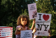 <p>A girl sitting on the shoulders of her father holds a sign reading “Keep Families Together” at a protest against President Trump’s proposed end of the DACA program that protects immigrant children from deportation, in New York City, Aug. 30, 2017. (Photo: Joe Penney/Reuters) </p>