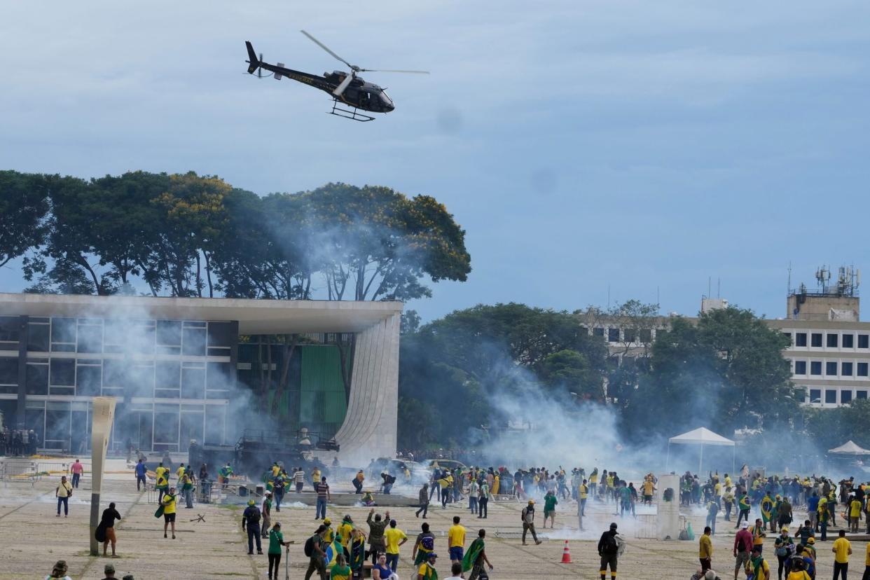 Mandatory Credit: Photo by Eraldo Peres/AP/Shutterstock (13702583aw) Protesters, supporters of Brazil's former President Jair Bolsonaro, clash with police as they storm the Planalto Palace in Brasilia, Brazil, . Planalto is the official workplace of the president of Brazil Elections Protest, Brasilia, Brazil - 08 Jan 2023