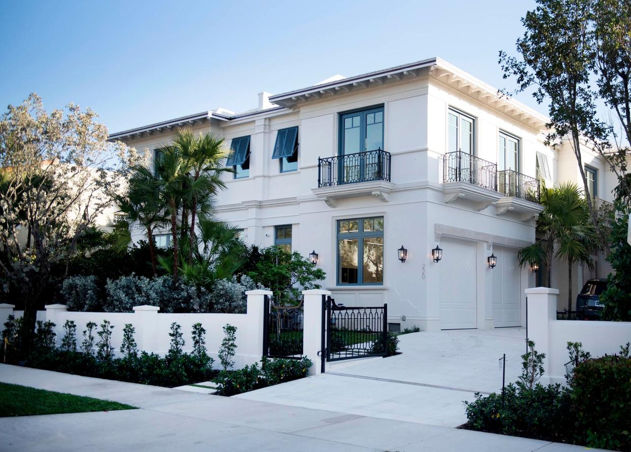 A gated driveway leads to a townhouse in a duplex at 220 Brazilian Ave. The townhome, on the west side of the development, just changed hands for $14.35 million, the price recorded with the deed.