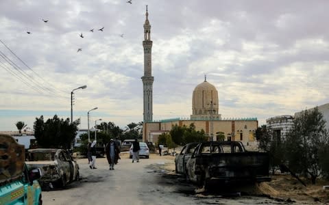 Wreckages of cars are seen after the Egypt Sinai mosque bombing - Credit: Stringer/Anadolu Agency/Getty Images