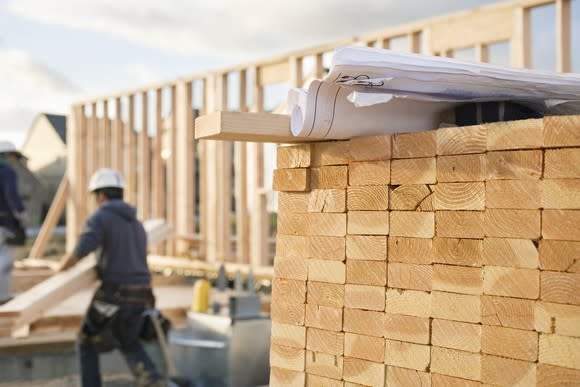 A closeup of a stack of 2 by 4's at a construction site.