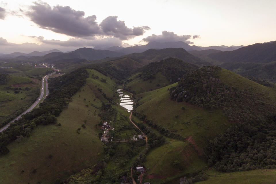 A road winds between fragmented areas of the Atlantic Forest in Casimiro de Abreu, Brazil, Thursday, April 18, 2019. (AP Photo/Leo Correa)