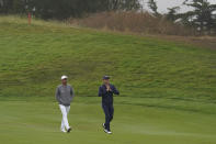 Rickie Fowler, left, and Justin Thomas walk on the 14th fairway during practice for the PGA Championship golf tournament at TPC Harding Park in San Francisco, Tuesday, Aug. 4, 2020. (AP Photo/Jeff Chiu)