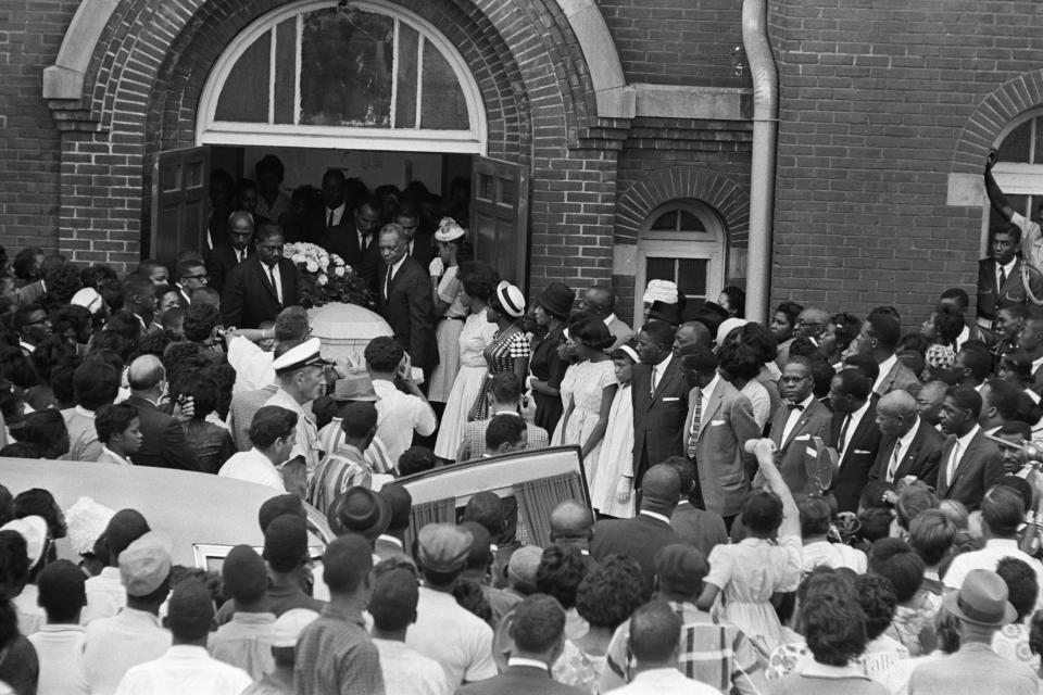 a photo of the mass crowds outside of the little girls funeral