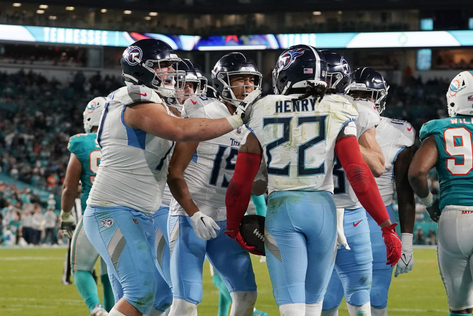 Tennessee Titans running back Derrick Henry (22) is congratulated by his teammates after scoring a touchdown during the second half of an NFL football game against the Miami Dolphins, Monday, Dec. 11, 2023, in Miami. (AP Photo/Lynne Sladky)