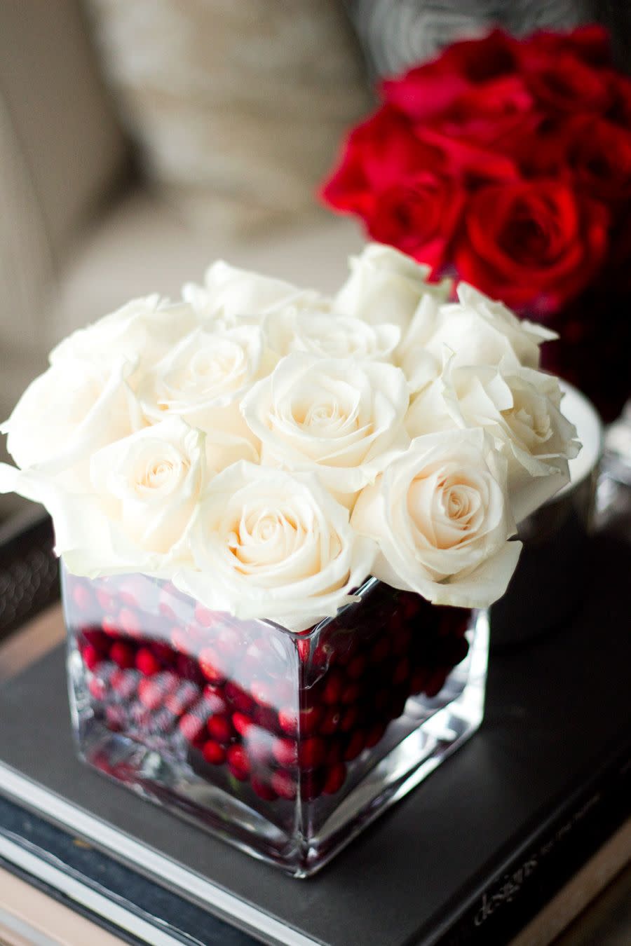 <p>Get creative with the base filler of your winter floral arrangements—try filling a square vase with fake cranberries before inserting cream colored roses.</p><p>Get the tutorial at <a href="http://notyourstandard.com/holiday-roses/" rel="nofollow noopener" target="_blank" data-ylk="slk:Not Your Standard;elm:context_link;itc:0;sec:content-canvas" class="link ">Not Your Standard</a>.</p>