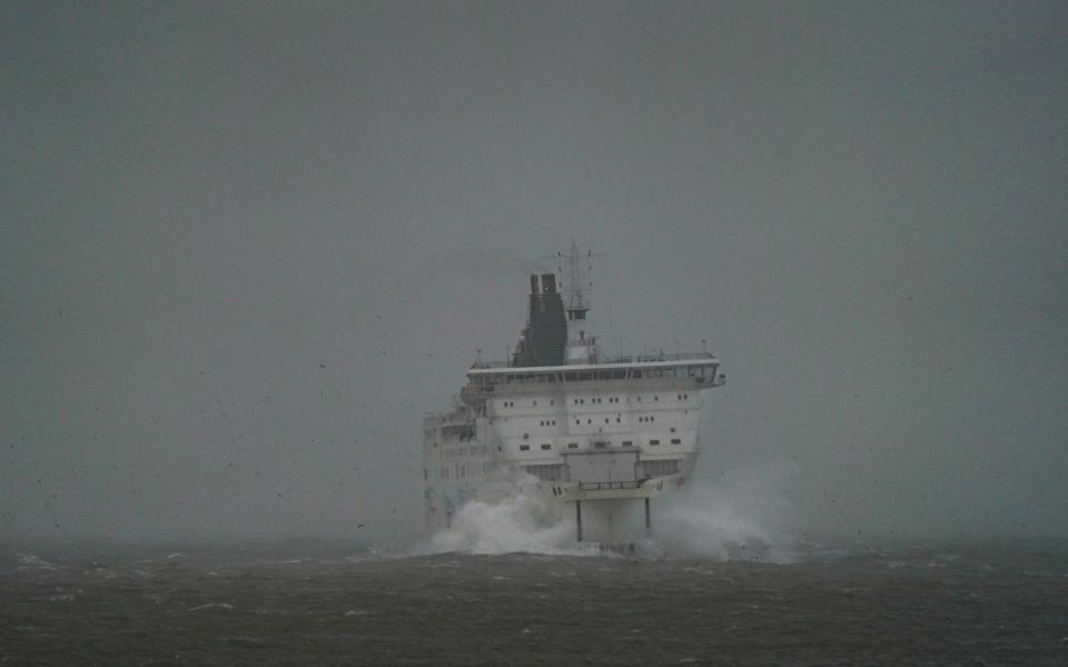 A DFDS ferry makes its way through choppy waters at Port of Dover in Kent (PA)