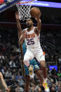 Phoenix Suns forward Mikal Bridges (25) drives on Detroit Pistons guard Alec Burks (5) in the first half of an NBA basketball game in Detroit, Saturday, Feb. 4, 2023. (AP Photo/Paul Sancya)