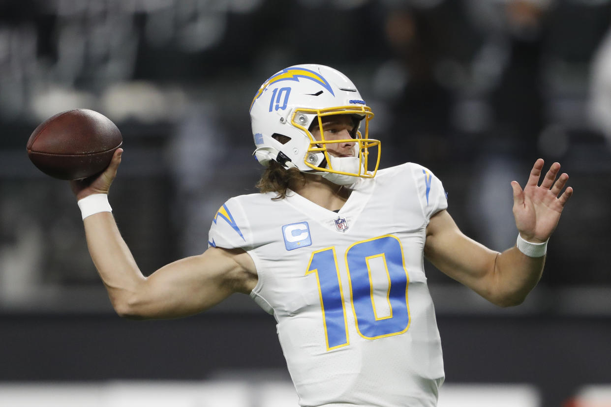 LAS VEGAS, NEVADA - JANUARY 09: Justin Herbert #10 of the Los Angeles Chargers warms up before playing against the Las Vegas Raiders at Allegiant Stadium on January 09, 2022 in Las Vegas, Nevada. (Photo by Steve Marcus/Getty Images)